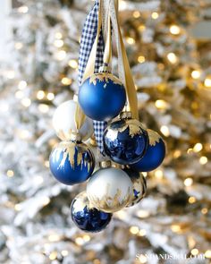 blue and white ornaments hanging from a christmas tree