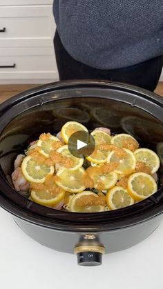 the slow cooker is full of lemons and chicken