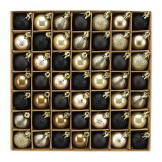 a wooden box filled with lots of different types of christmas ornament ornaments in gold and black