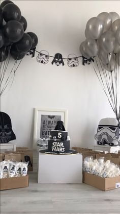 star wars themed birthday party with balloons, cake and desserts on the table in boxes