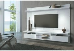 a white entertainment center with a flat screen tv mounted on it's side wall