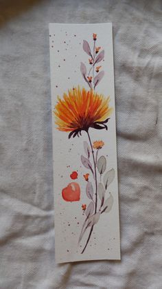 a watercolor painting of a flower on a white sheet with orange and yellow petals