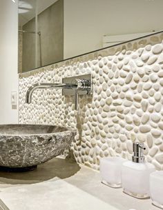 a bathroom sink sitting under a mirror next to a faucet