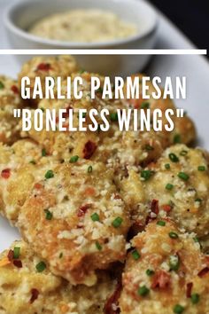 garlic parmesan'boneless wings on a plate with dipping sauce in the background