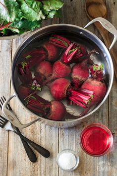 beets are in a pot on the table next to utensils and other ingredients