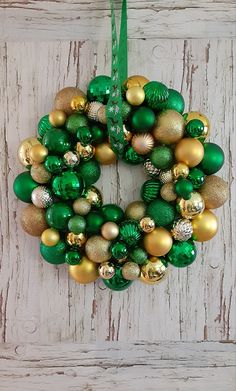 a wreath made out of green and gold ornaments