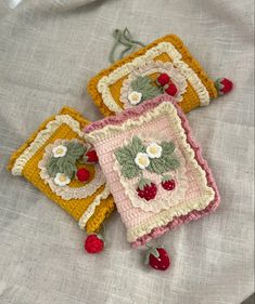 three crocheted squares with cherries on them