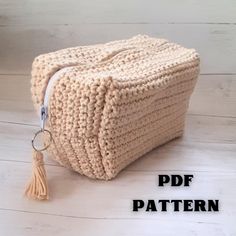 a crocheted bag with a tassel hanging from it