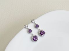 Purple Amethyst Earrings, Cubic Zirconia Amethyst Earrings, Bridesmaids Earrings, Purple and White  Round Drop Cubic Zirconia Long Dangle EarringsThe earrings are made with high quality hypoallergenic rhodium plated cubic zirconia ear posts (925 sterling silver posts) and 9mm and 14mm rhodium plated white and purple amethyst cubic zirconia round drops.The earrings measure 1 1/2 inch (38mm).*****All metal Components are Hypoallergenic, High quality plated, Anti tarnish and have Long lasting color Purple Prong Set Earrings For Wedding, Purple Wedding Earrings With Prong Setting, Purple Prong Set Wedding Earrings, Purple Cubic Zirconia Earrings For Wedding, Purple Amethyst Earrings, Bridesmaids Earrings, Earrings Purple, Long Dangle Earrings, Cubic Zirconia Earrings