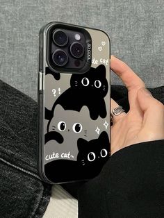 someone is holding up their phone case with cats on it