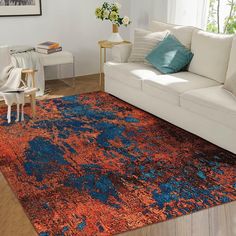 an orange and blue rug in a living room