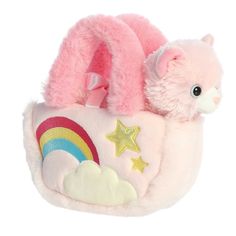 a stuffed animal in a pink purse with rainbows and stars on the side,