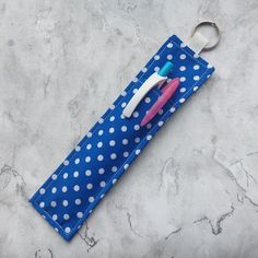 a blue and white polka dot bag with a toothbrush holder