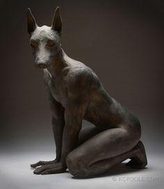 a sculpture of a dog sitting on the ground