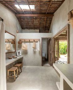 the inside of a bathroom with wooden accents