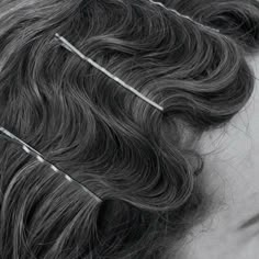 a woman with hair pins in her hair