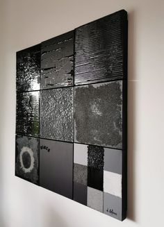 a black and white painting hanging on the wall