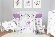 a baby crib bedding set with purple flowers