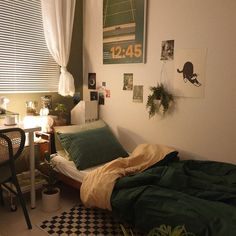 a small room with a bed, desk and chair in the corner next to a window