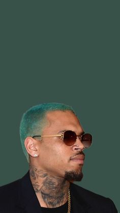 a man with green hair wearing sunglasses