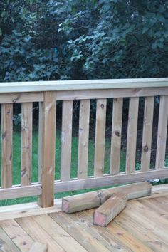 a wooden deck with logs laying on the ground