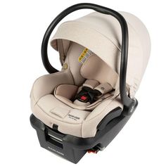 an infant car seat with a black handle on the front and back end, in beige fabric