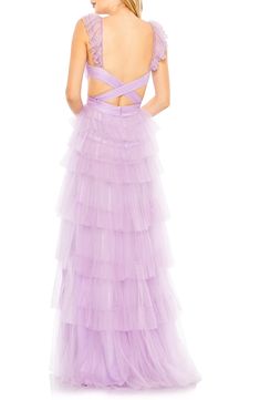 Look every part the princess in this tiered tulle gown that features waist-wrapping cutouts and fluttery, sequinned cap sleeves. 61" length Deep V-neck Cap sleeves Lined 100% polyester Spot clean Imported Asian Owned/Founded Mode Purple, Vestidos Color Coral, Tiered Tulle Skirt, Tulle Gown, Mac Duggal, Tulle Fabric, Purple Fashion, The Princess, Sweetheart Neckline