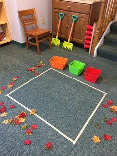 a child's play room with toys and leaves on the floor