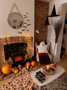 a living room decorated for halloween with pumpkins and decorations on the fireplace mantel