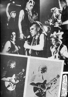 black and white photograph of people playing guitars in front of a wall with pictures on it