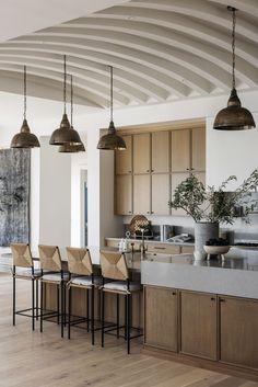 a kitchen filled with lots of counter top space next to a dining room table and chairs