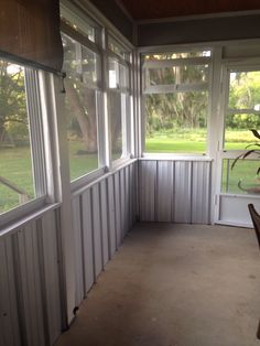 the inside of a sun room with windows on both sides and blinds off to the side