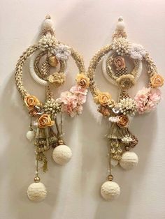 two wall hangings with flowers and pearls on the top one is made out of beads