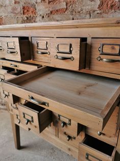 an old wooden desk with drawers on it