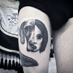 a woman with a dog's head on her thigh is shown in black and white