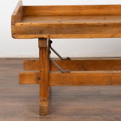 an old wooden bench sitting on top of a hard wood floor