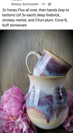 two vases sitting on top of each other next to pink flowers