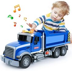 a little boy playing with a toy dump truck and musical notes on the side of it