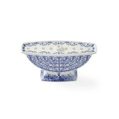 a blue and white bowl with dots on the rim, sitting in front of a white background