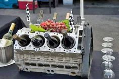 the engine block is sitting next to some wine glasses