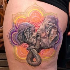 an elephant tattoo on the side of a woman's thigh