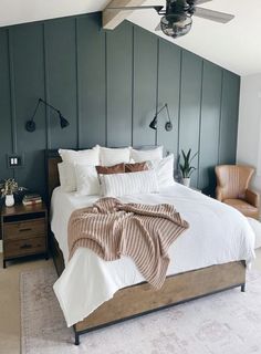 a large bed sitting under a ceiling fan in a bedroom