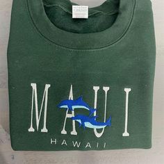 a green t - shirt that says i am hawaii with a dolphin on the front