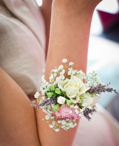 a woman holding a bouquet of white and pink flowers on her arm with the words anach written below it