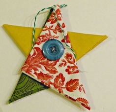 an origami star with a blue button on it