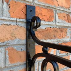 a close up of a brick wall with iron work on the outside and in front