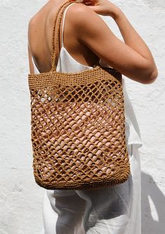 a woman carrying a straw bag on her back