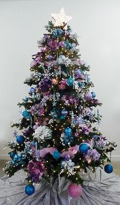 a decorated christmas tree with purple and blue ornaments