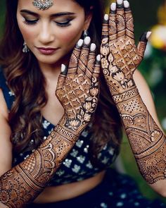 a woman with henna on her hands