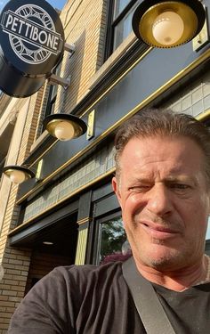 a man standing in front of a restaurant